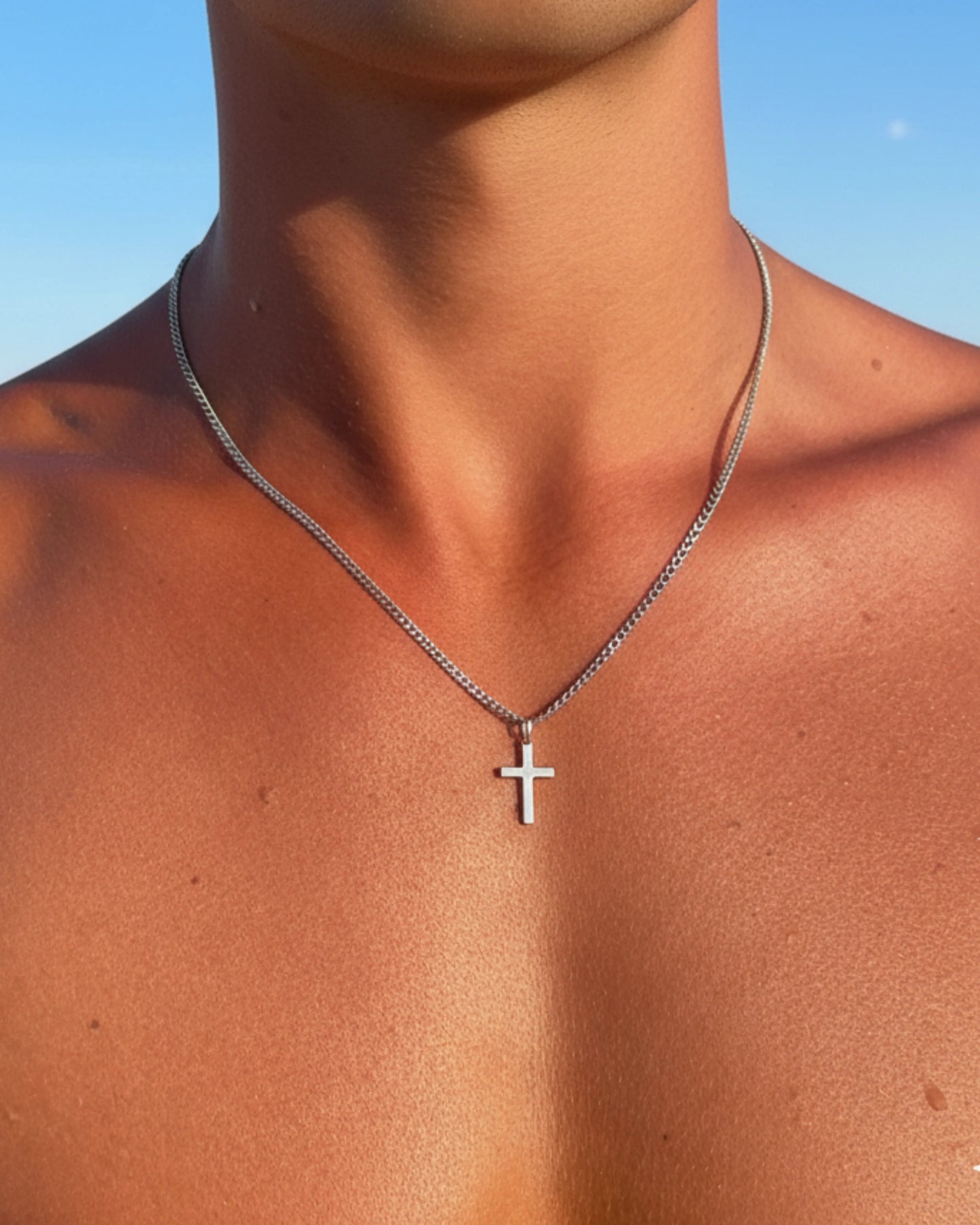 Silver cross chain close up on model image