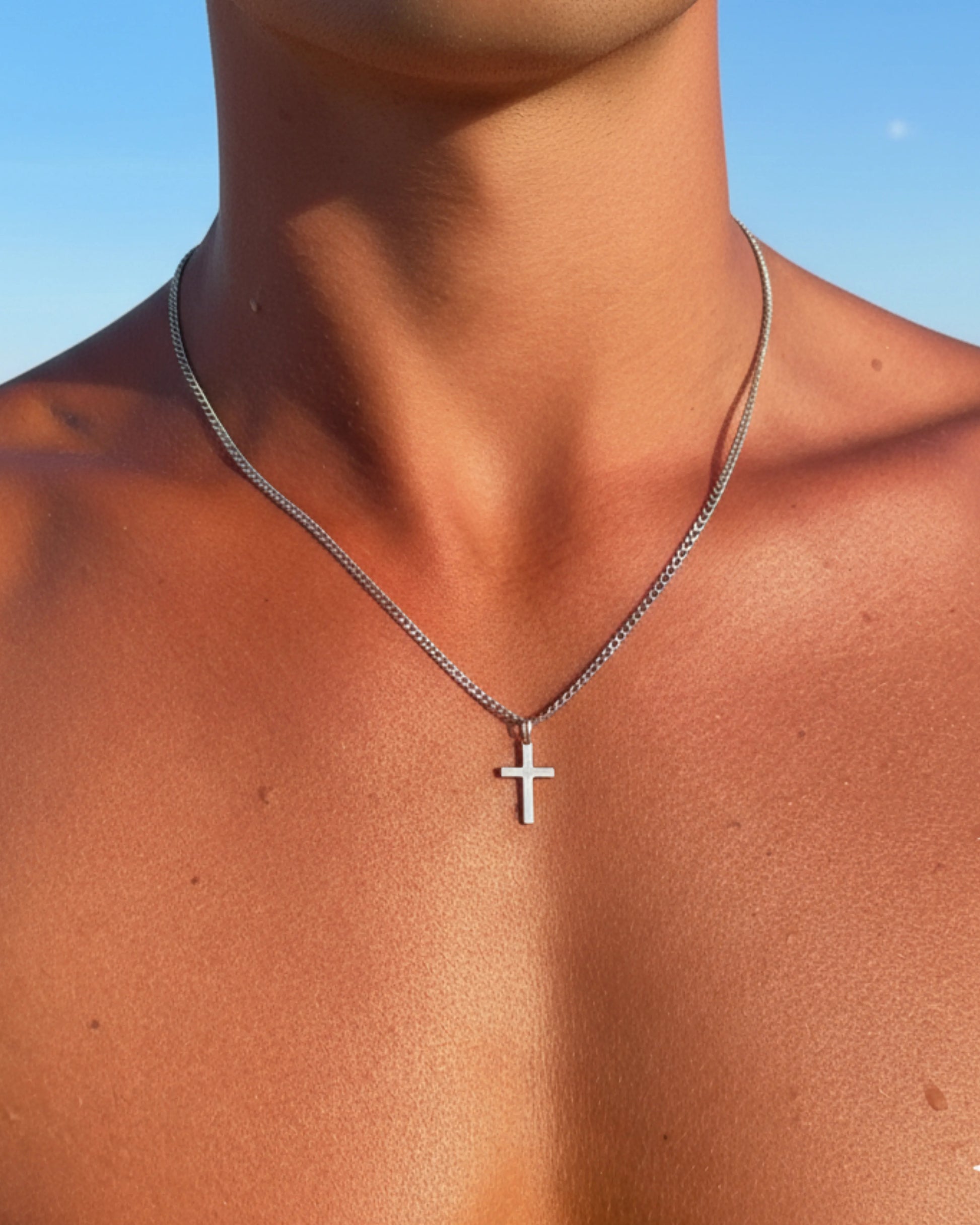 Silver cross chain close up on model image