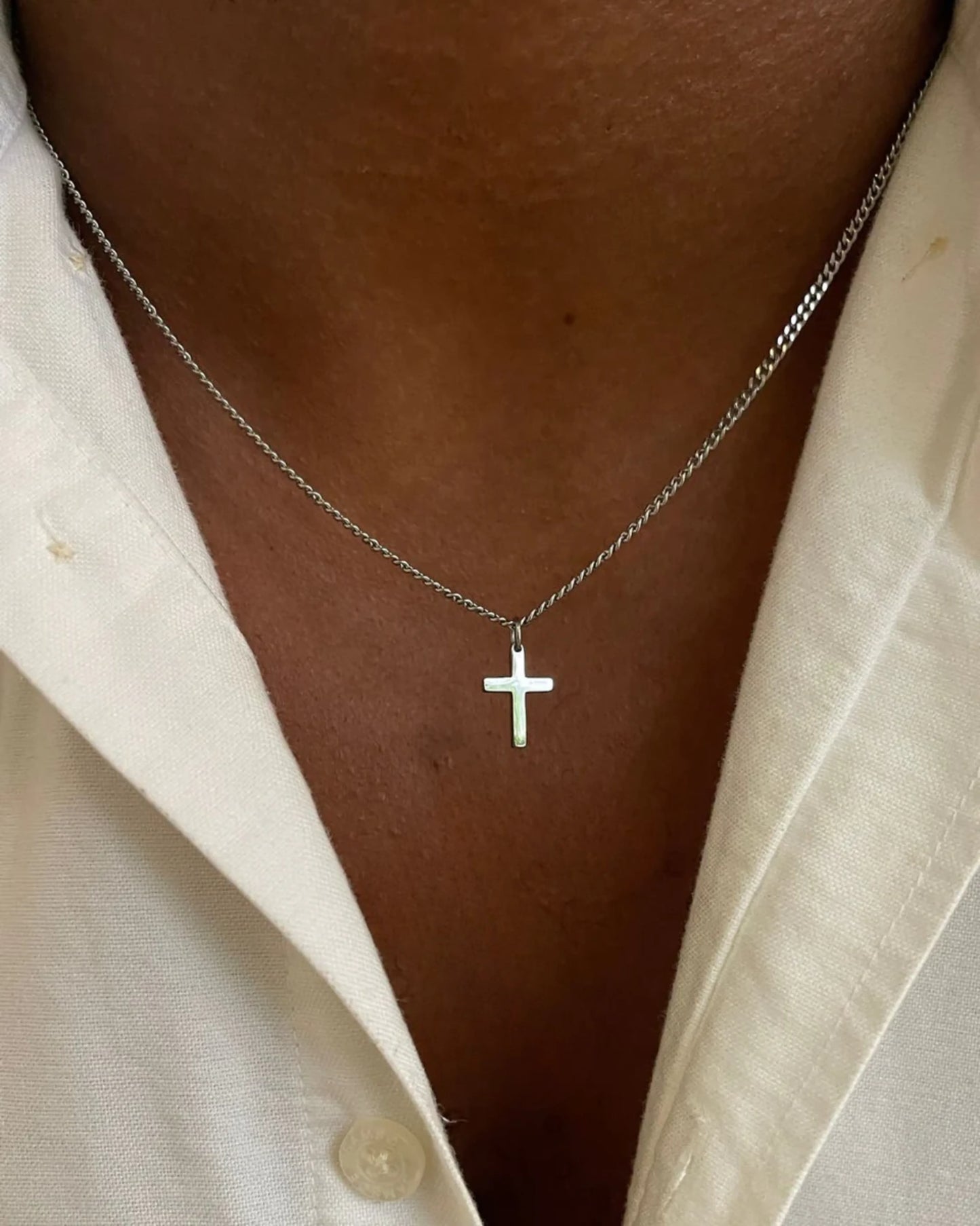 Silver cross chain on model image