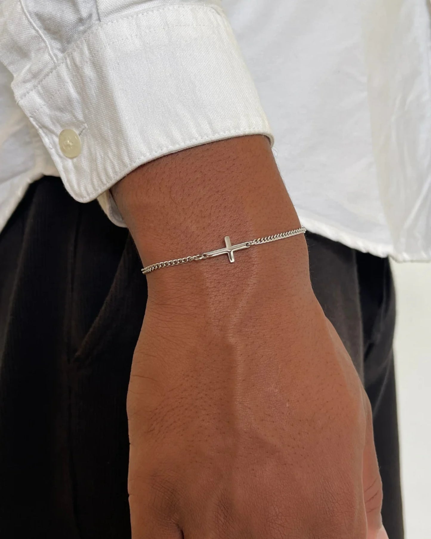 Silver cross bracelet on model image
