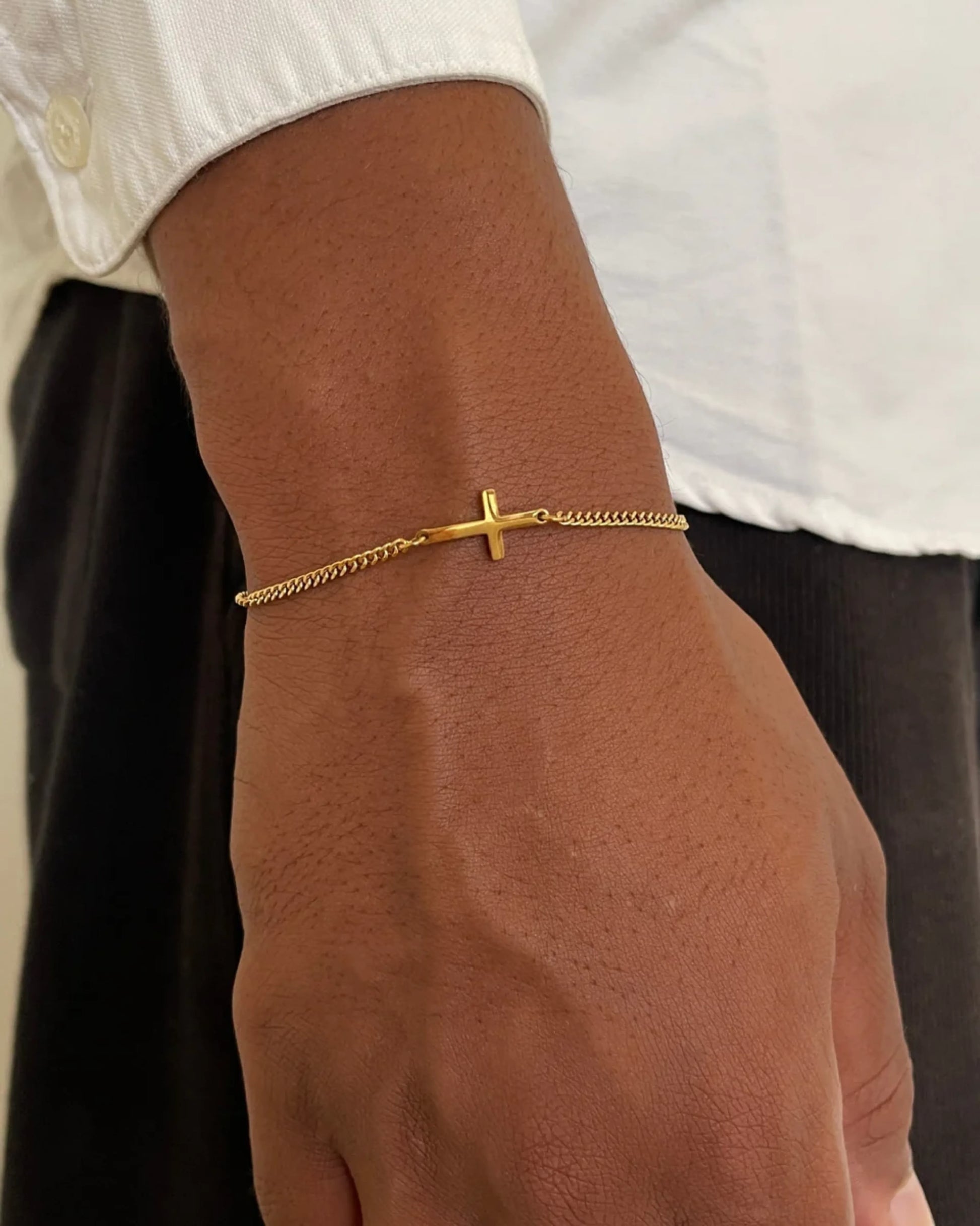Gold cross bracelet on model image