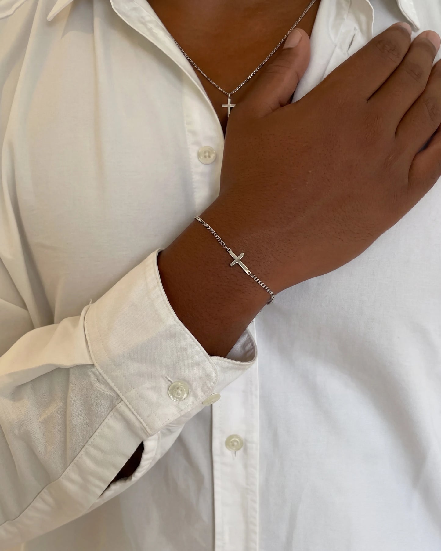 Silver cross chain + bracelet on model image