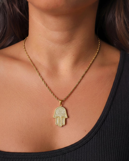 Hamsa hand chain gold on female model close up photo