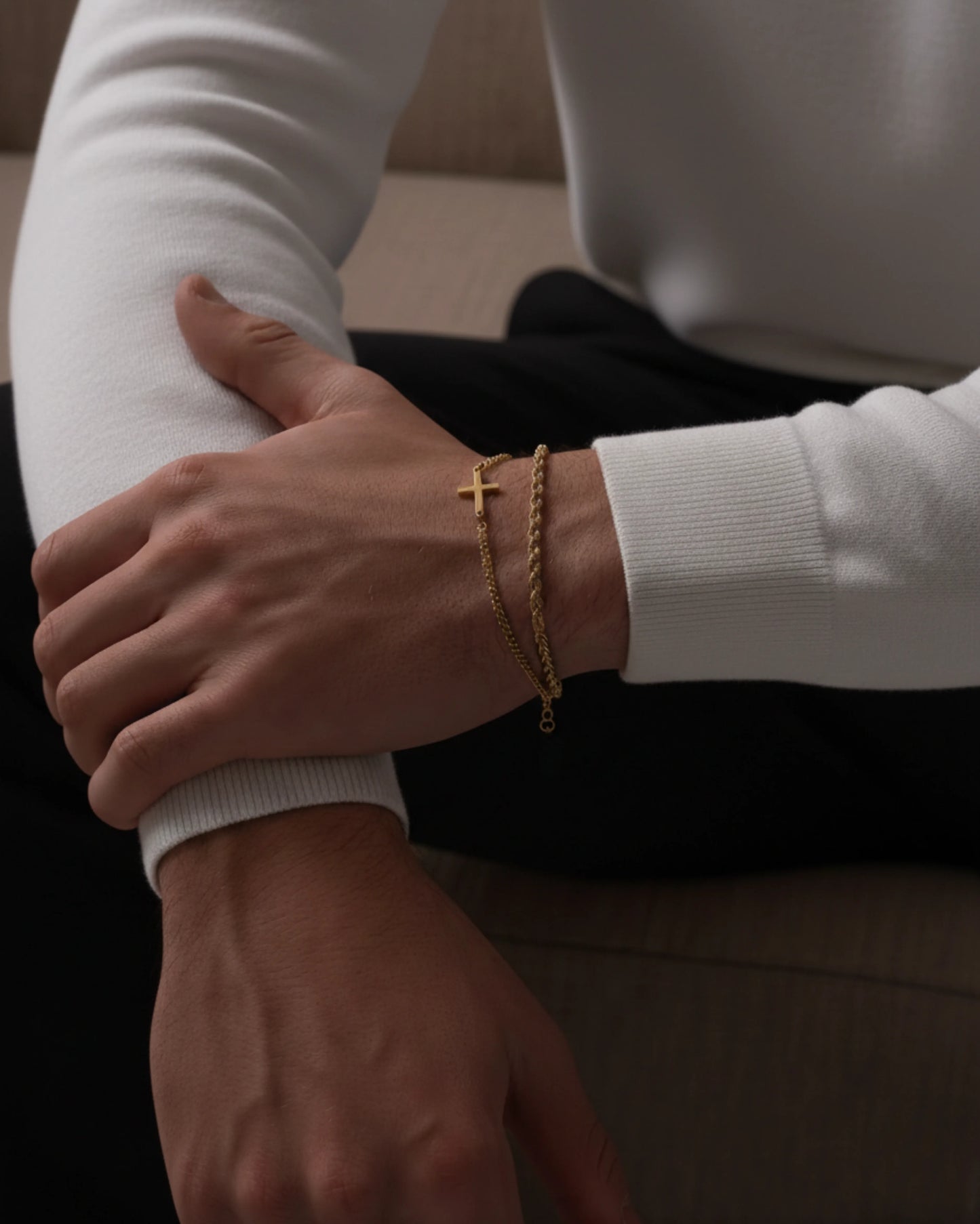 Gold cross bracelet on model image