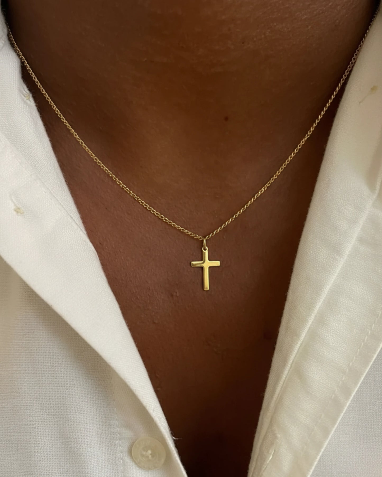 Gold cross chain on model close up image